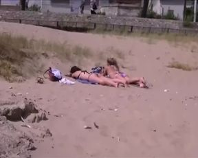 Two young girls taking a sunbath on the beach